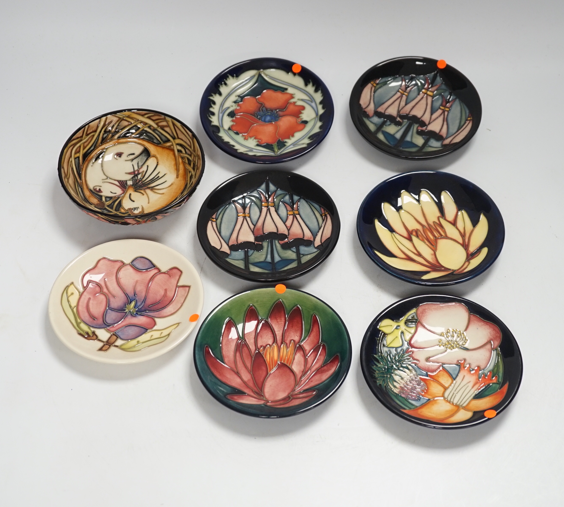 Seven Moorcroft floral dishes, two with Kerry Goodwin stamp to the base and a dormouse bowl designed by Emma Bossons, limited edition 14/100, 12cm in diameter